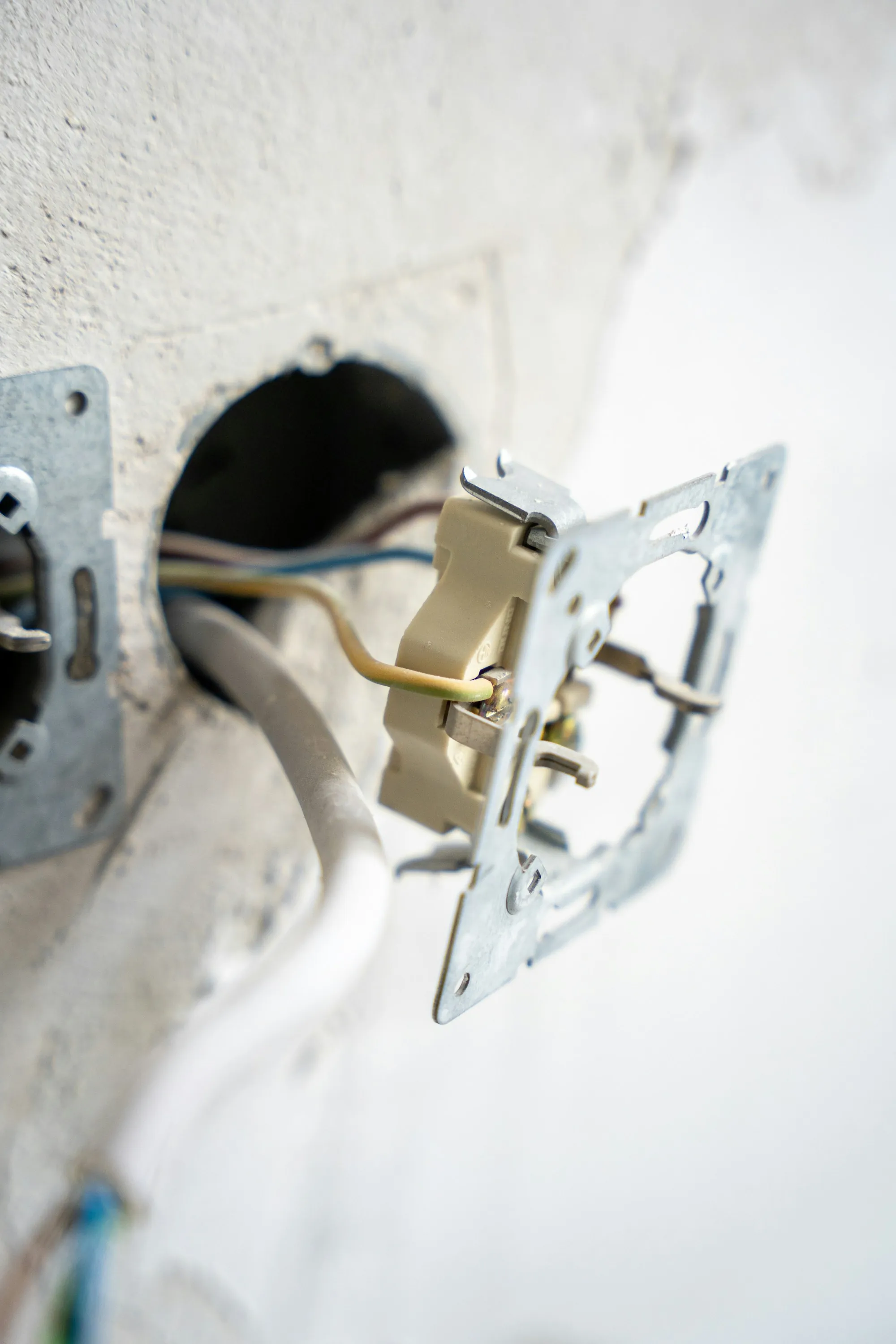Electrician mounting a new switch box on a wall