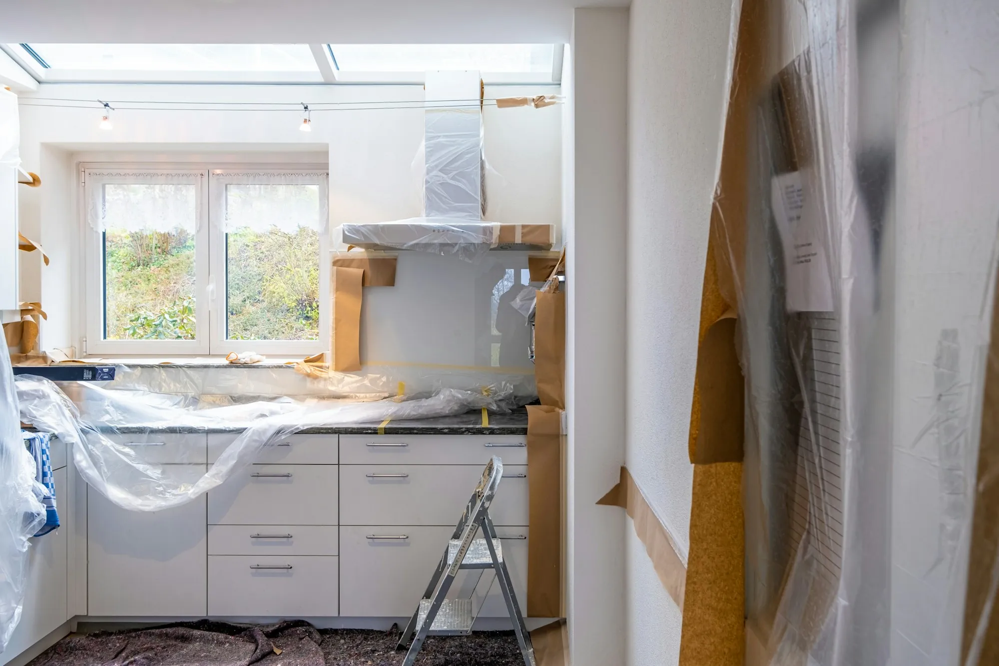 Kitchen under renovation with new cabinets and exposed walls