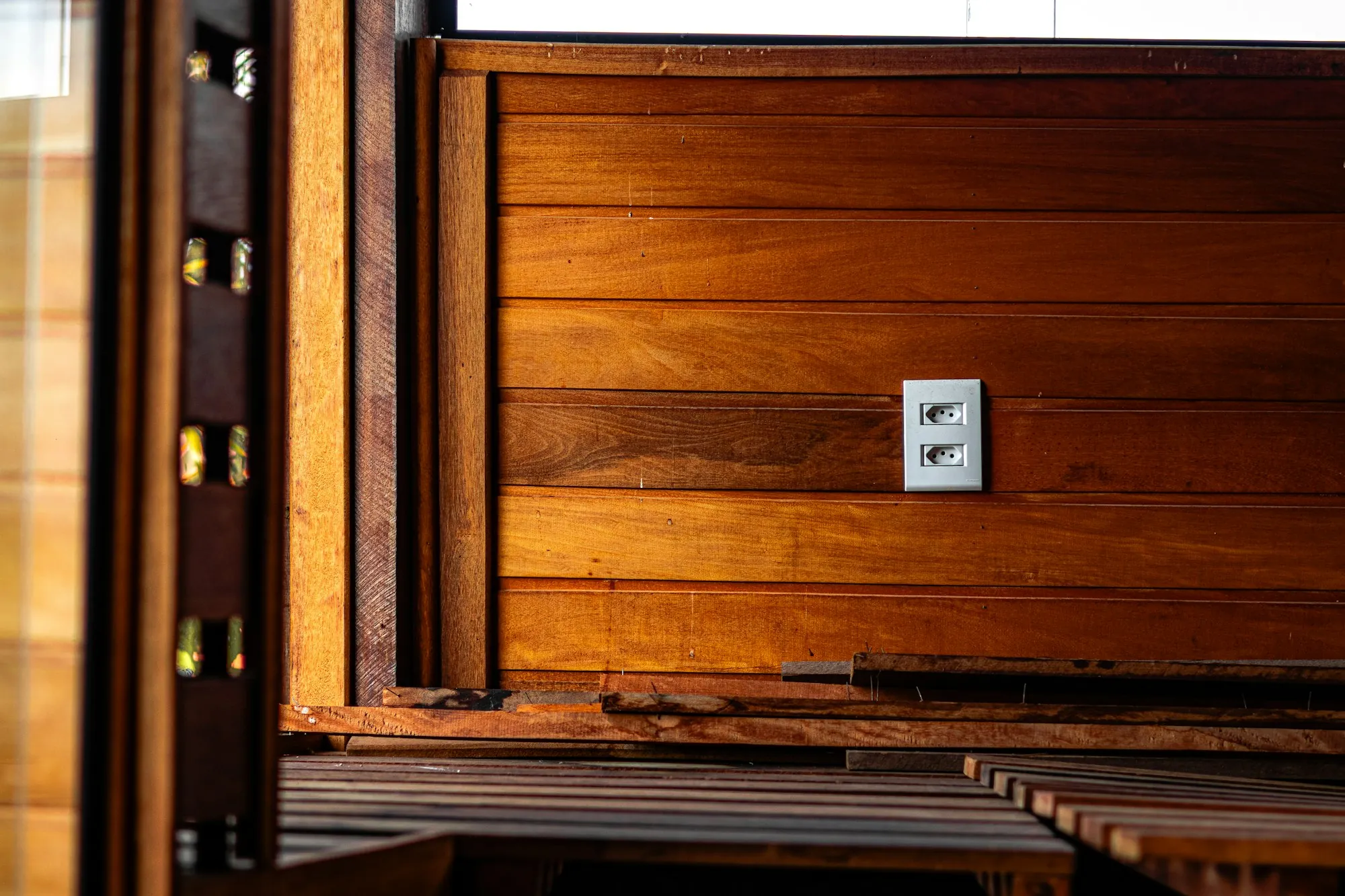 New outlet set into a warm wooden wall panel